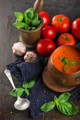 Obraz na płótnie Canvas Tomato and fresh basil soup with garlic, served with cream