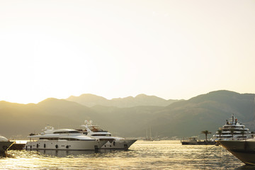 Obraz premium Vacation wallpaper with sea and yachts. Luxury sea expensive multi-deck yacht moored on the pier.