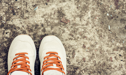 Fototapeta na wymiar Sneakers of grey suede on the sidewalk.