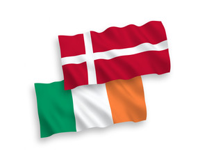 National vector fabric wave flags of Ireland and Denmark isolated on white background. 1 to 2 proportion.