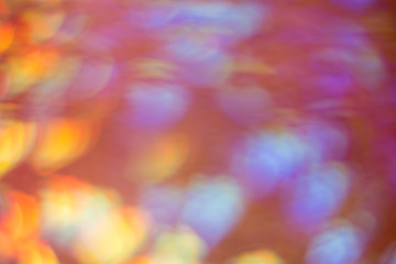 Festive abstract background with bokeh defocused lights. Multicolor lens flare glow.