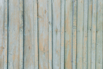 Old wooden background of boards with cracked and peeling paint. Wooden texture of fence