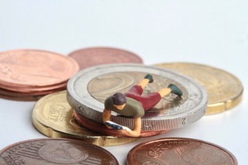 miniature of people reading and euro coins