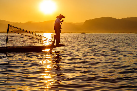 Myanmar travel attraction landmark - Traditional Burmese fisherman at Inle lake, Myanmar famous for their distinctive one legged rowing style