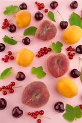 Fruit berry pattern. Ripe apricots and peaches, sweet cherry and red currants with green leaves on a pink background.Summer fruits. top view.summer fruit  phone wallpaper 