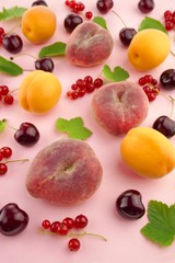 Fruit berry pattern.  apricots and peaches, sweet cherry and red currants with green leaves on a pink background.Summer fruits. top view.Summer season.summer fruit  phone wallpaper 