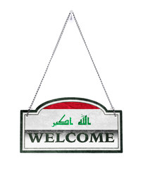 Iraq welcomes you! Old metal sign isolated