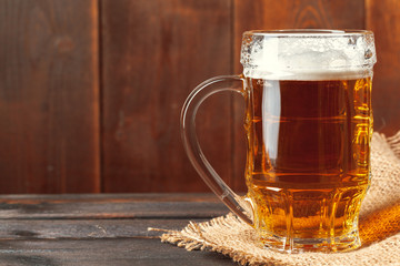 Glass beer on wood background