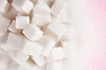 Cubes of sugar on bright pink background
