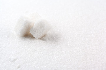Fototapeta na wymiar scoop with white sand and lump sugar close up background