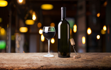 Expensive wine bottles collection and wooden barrel in the cellar, wine tasting and production...