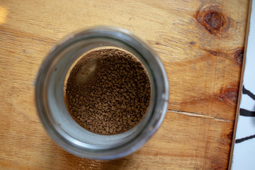 Almost Empty Instant coffee container on wooden surface