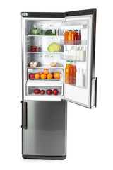 Big modern fridge with fresh products on white background