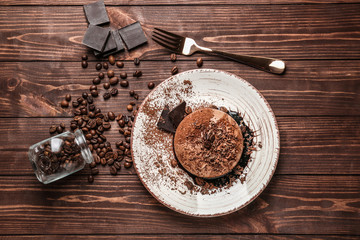 Plate with tasty panna cotta on wooden table