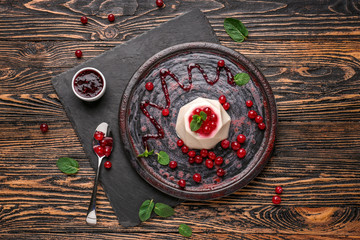 Plate with tasty panna cotta on wooden table - obrazy, fototapety, plakaty