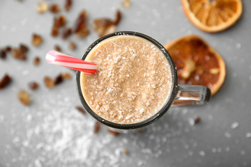 Glass cup of tasty frappe coffee on grey table, closeup
