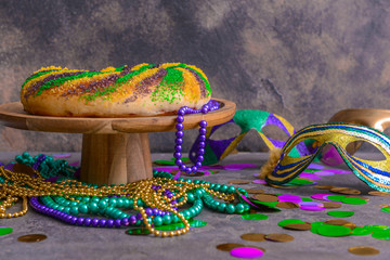 Festive cake for Mardi Gras (Fat Tuesday) holiday with decor on grey table © Pixel-Shot