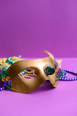 Festive mask on color background