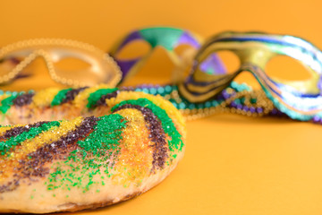 Festive cake for Mardi Gras (Fat Tuesday) holiday with decor on color background