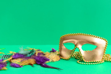 Festive mask with decor on color background