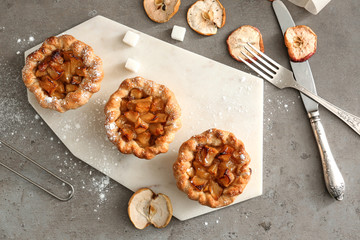 Tasty apple pies on grey table © Pixel-Shot
