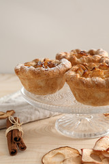 Dessert stand with tasty apple pies on wooden table