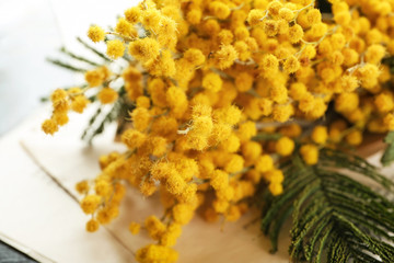 Bouquet of beautiful mimosa flowers on table, closeup