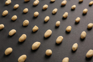 Tasty peanuts on dark background