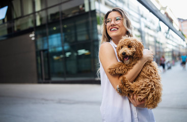 Happy young woman with her dog in the summer