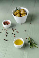 Bowl with tasty olive oil and spices on wooden table