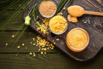Jar with sugar scrub on wooden table