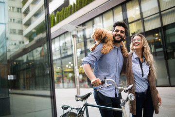 Romantic couple is having rest in the city with dog and bicycles