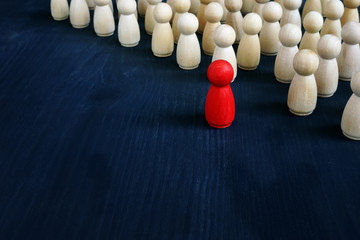 Stand out from the crowd concept. Uniqueness and individuality. Line of figurines.