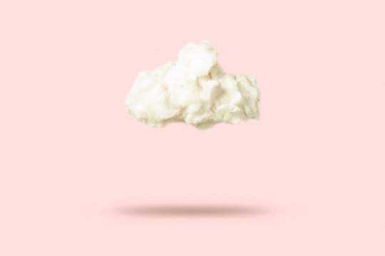 Cloud Of Cotton Wool On A Pink Background. Weather Concept.