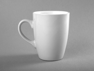 Empty white mug on a gray background.