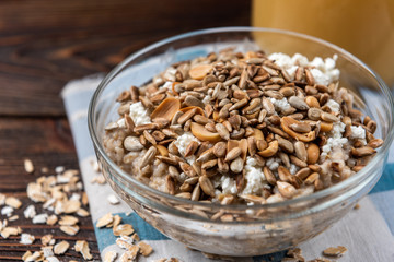 Oatmeal with cottage cheese, honey, peanut and sunflower seeds.