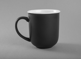 Empty gray mug on a gray background.