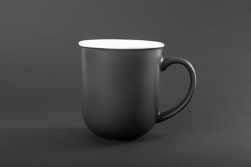 Empty gray mug on a gray background.