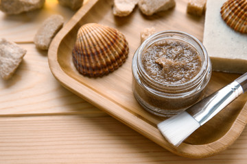 Obraz na płótnie Canvas Jar with sugar scrub and ingredients on wooden table