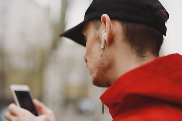 Man listening music in wireless earbud headphones