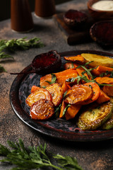Plate with tasty cooked vegetables on dark table