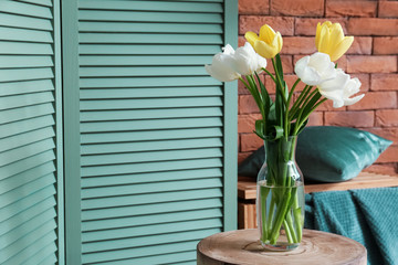 Bouquet of beautiful tulips on table in room
