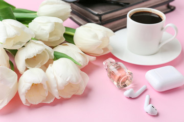 Fototapeta na wymiar Composition with beautiful tulips, female accessories and cup of coffee on color background
