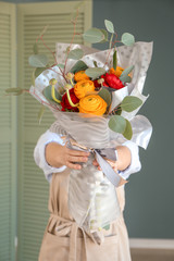 Florist holding beautiful bouquet in shop