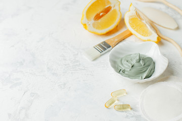 Natural herbal skin care products, top view ingredients volcanic clay mask, lemon on table concept natural face care. Facial treatment preparation background