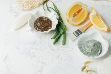 Natural herbal skin care products, top view ingredients coffee scrub and beans, aloe vera, clay, honey on table concept natural face care. Facial treatment preparation background