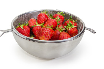 Washed strawberries in stainless steel sieve and bowl