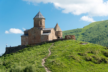 Fototapeta na wymiar Kazbegi, Georgia - Jun 28 2018: Gergeti Trinity Church on Kazbegi National Park in Kazbegi, Mtskheta-Mtianeti, Georgia.