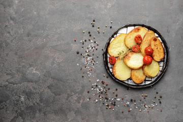 Plate with tasty baked potato on grey table