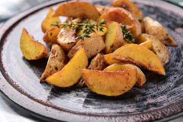 Plate with tasty baked potato, closeup